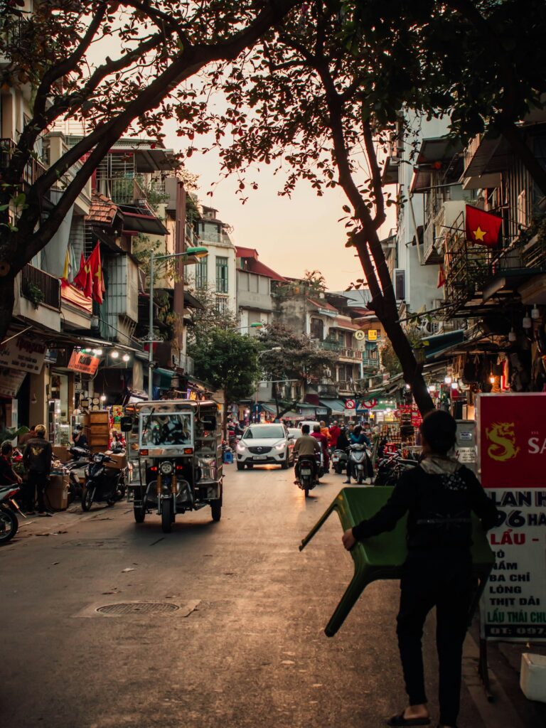 A cafe on a street corner in Hanoi's Old Quarter amid morning motorbike traffic