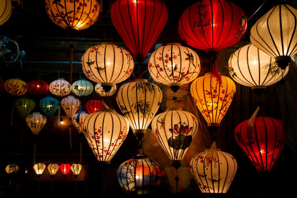 Handmade silk lanterns glowing in a Hoi An lantern shop