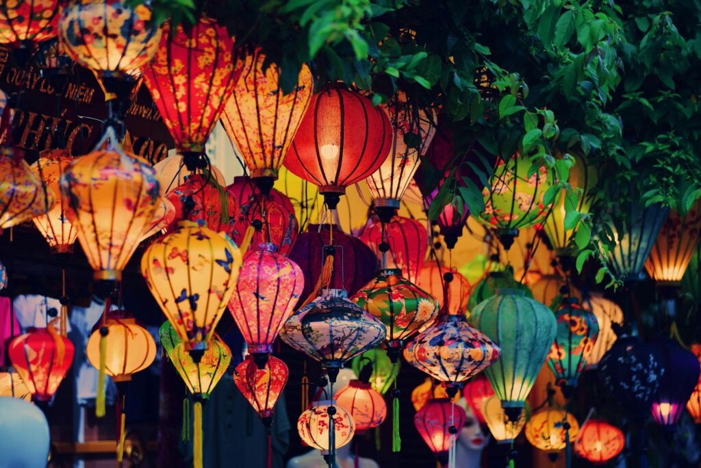 Handmade silk lanterns glowing in a Hoi An lantern shop