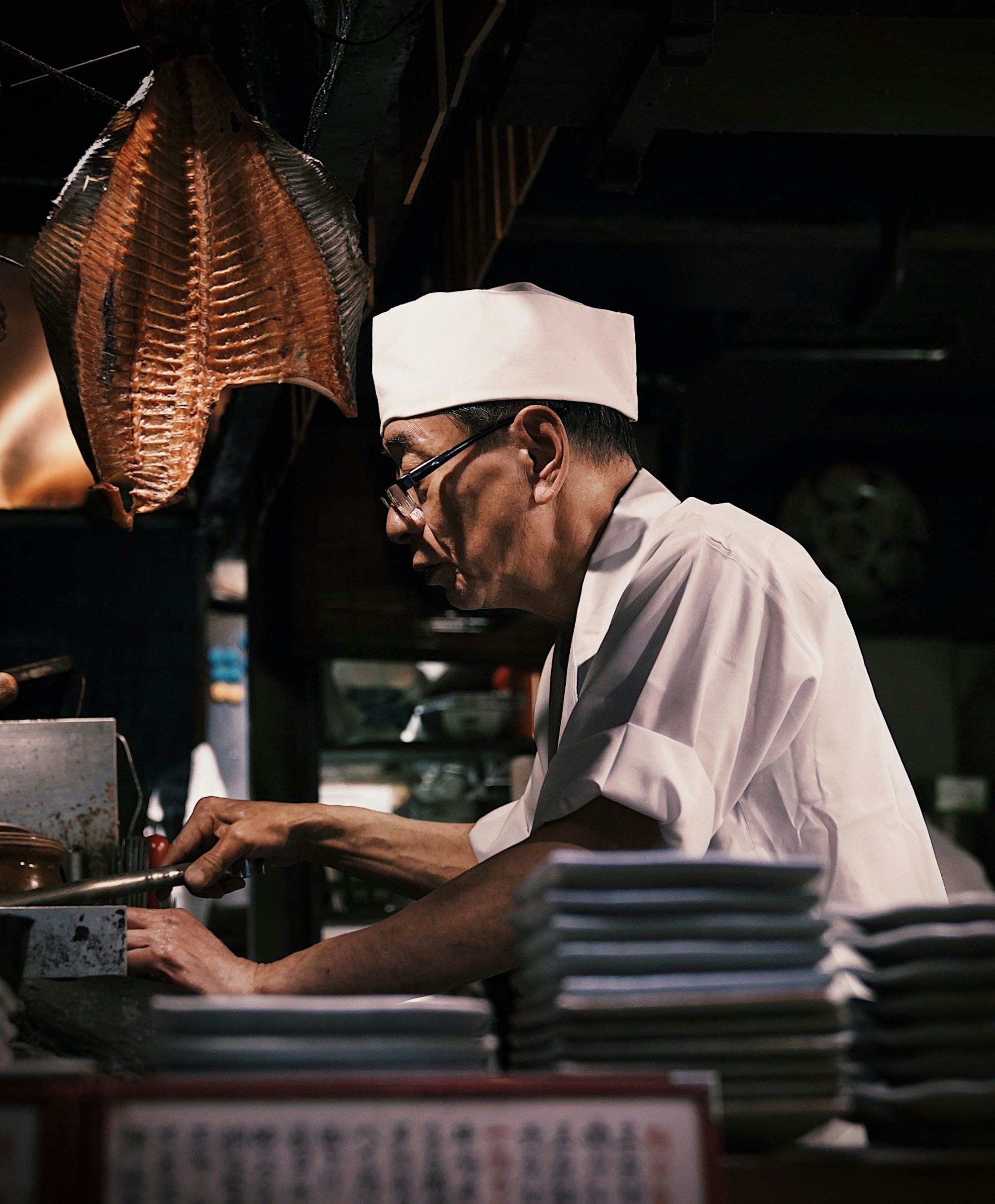 Japanese chef at work in a traditional kitchen — Japan's Table: A Culinary Journey