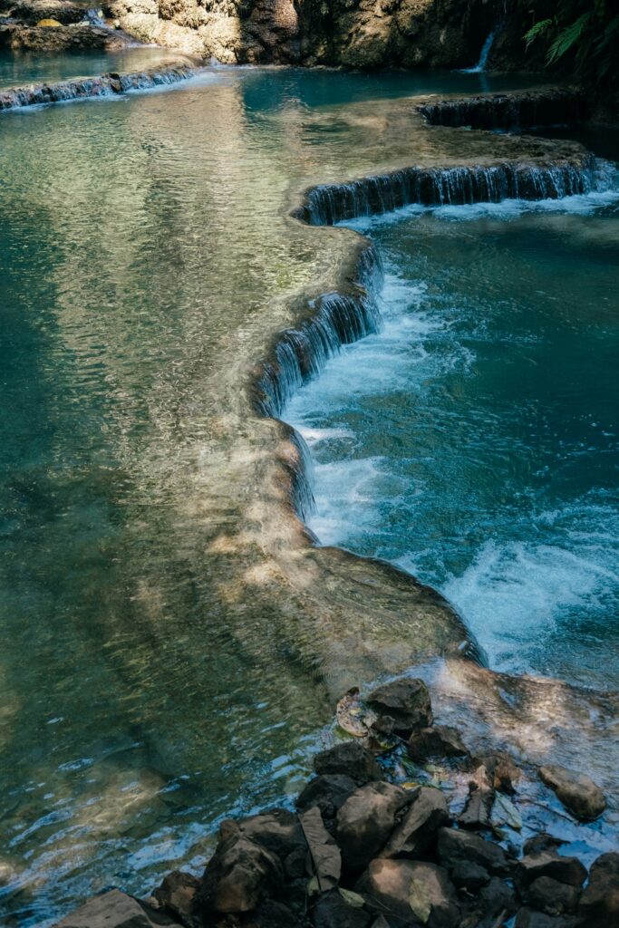 Bright turquoise jungle waterfall pool