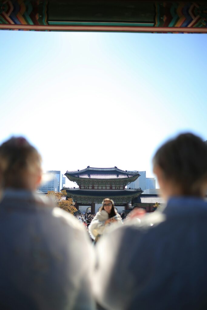 Korean family hanbok enjoying palace courtyard wide