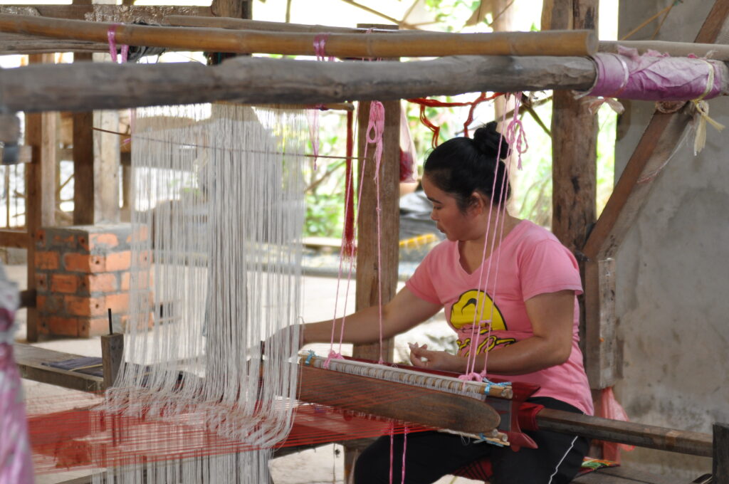 Weaver creating traditional Laotian textiles