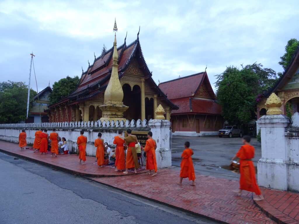 Monks receiving alms at dawn in Luang Prabang