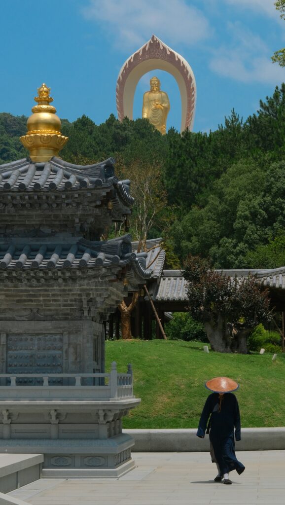 Korean rock-cut grotto temple sunlit entrance golden Buddha exterior
