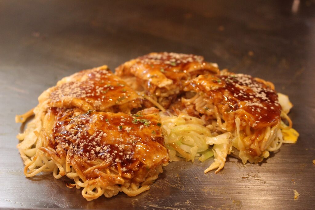 Hiroshima-style okonomiyaki served on a hot plate