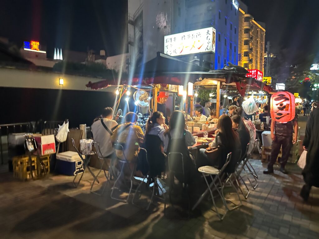 Diners gathered around a nighttime yatai food stall in Hakata