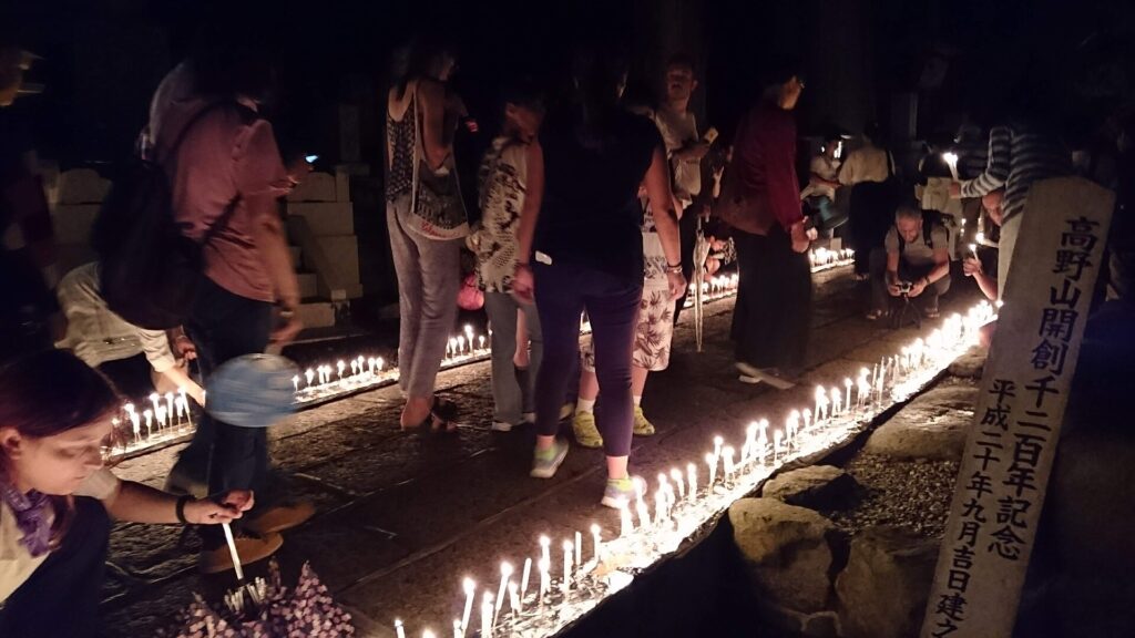 Visitors lighting candles at Okunoin cemetery in Koyasan